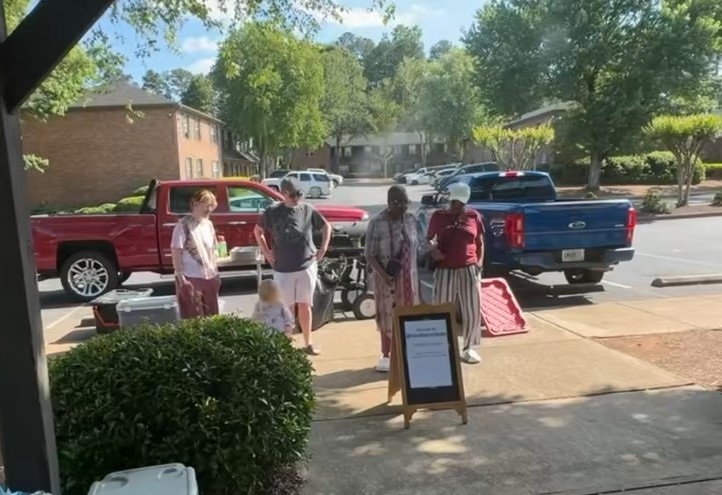 Residents gathered at the Iron Barrel Eats table during an apartment community event